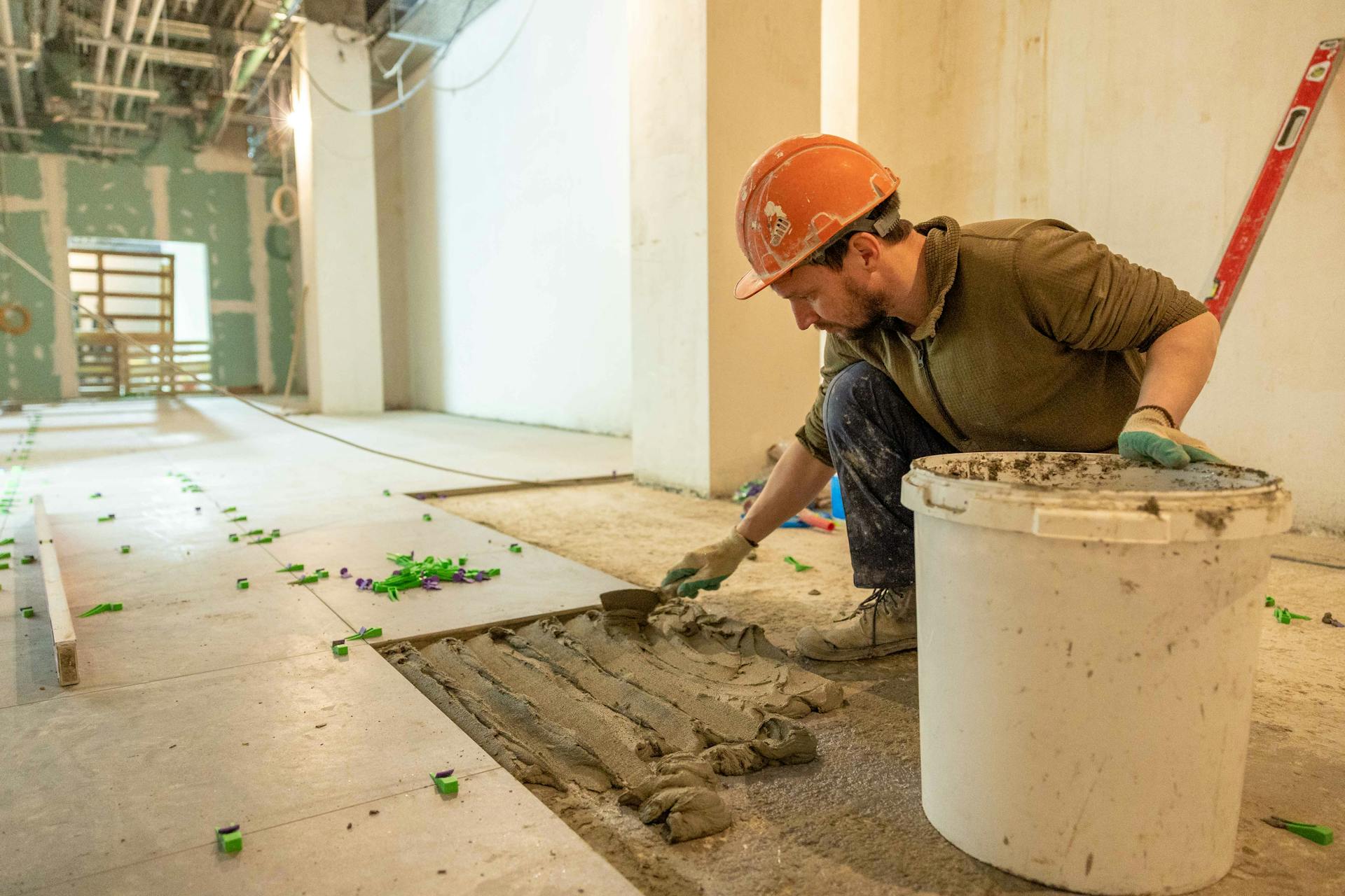 Sydney Sealed tradesperson laying tiles — hands-on leak repair craftsmanship